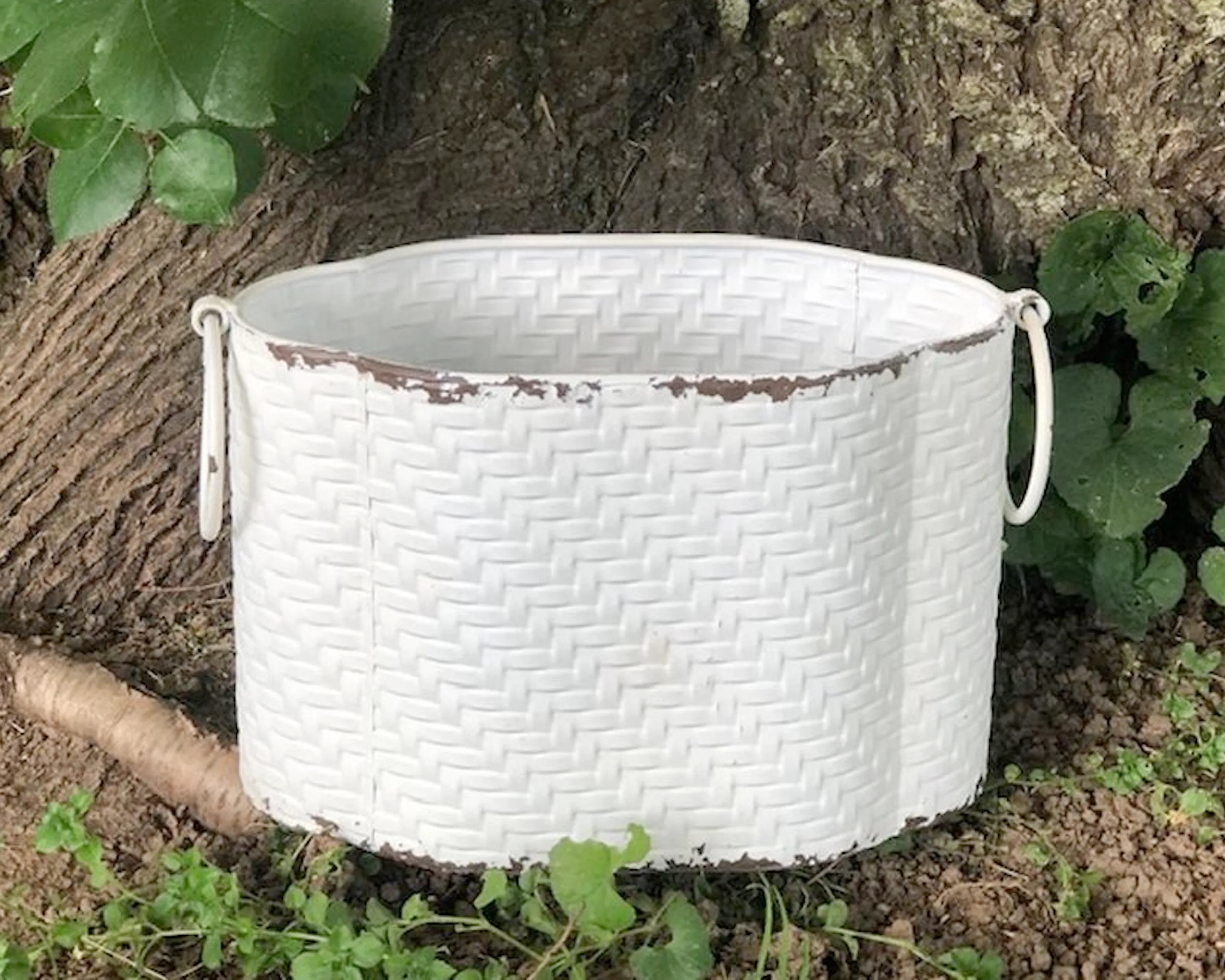 Distressed oval wicker decorative container
