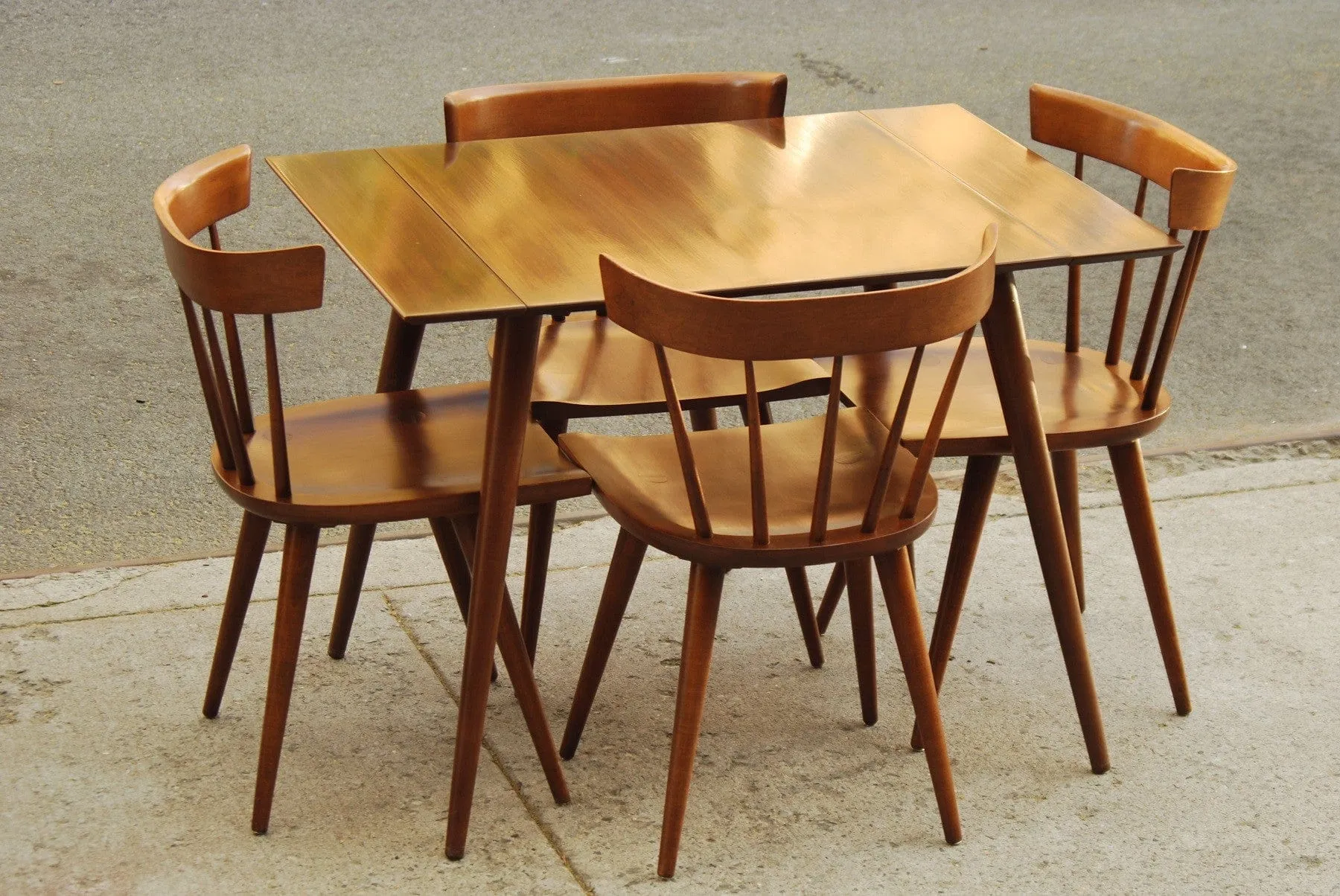 SOLD -- PAUL MCCOBB COMPACT DINING SET WITH TWO LEAVES AND FOUR CHAIRS